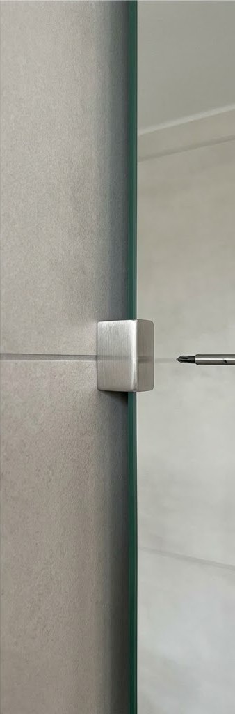 Befestigung eines Spiegels an der Fliesenwand mit Halter im Bereich der Fuge